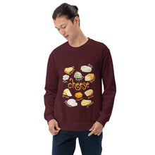 Load image into Gallery viewer, A man is wearing the Cheese Lovers Unisex Sweatshirt in the colour maroon, which is printed with a graphic of ten different types of cheeses
