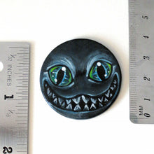 Load image into Gallery viewer, a portrait of an evil looking Cheshire Cat with an evil smile, hand painted on a wood disc. it&#39;s available as a keepsake or pendant necklace
