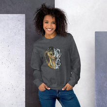Load image into Gallery viewer, A woman is wearing a unisex sweatshirt in the colour dark heather grey, printed with a graphic split into two: the left side features the face of a cobra snake, and the right side features an evil looking snake skull.
