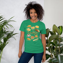 Load image into Gallery viewer, A woman is wearing the Cookie Lovers Unisex Premium T-shirt in the colour kelly green, with a graphic of 10 different types of cookies

