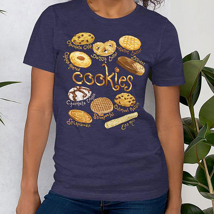 A woman is wearing the Cookie Lovers Unisex Premium T-shirt in the colour heather midnight navy, features a graphic of 10 different types of cookies.