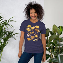 Load image into Gallery viewer, A woman is wearing the Cookie Lovers Unisex Premium T-shirt in the colour heather midnight navy, features a graphic of 10 different types of cookies.
