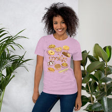 Load image into Gallery viewer, A woman is wearing the Cookie Lovers Unisex Premium T-shirt in the colour  heather prism lilac, with art of 10 different cookies.
