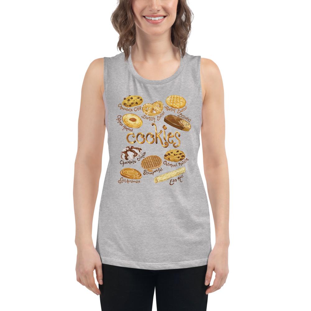A woman is wearing the Cookie Lovers Women's Muscle Tank Top in the colour athletic heather grey, which is printed with artwork of 10 different types of cookies