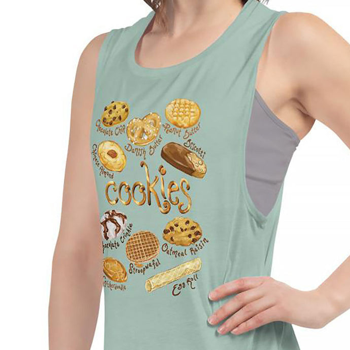 A woman is wearing the Cookie Lovers Women's Muscle Tank Top in the colour dusty blue, which is printed with a graphic of 10 different types of cookies