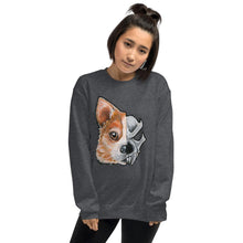 Load image into Gallery viewer, A woman is wearing a unisex sweatshirt in the colour dark heather grey, which is printed with a split graphic: the left side features the art of a corgi dog&#39;s face, and the right side features an evil looking skull
