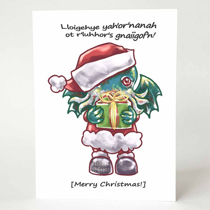 a greeting card with an illustration of a Cthulhu dressed as Santa Claus, holding a gift. The card reads,  