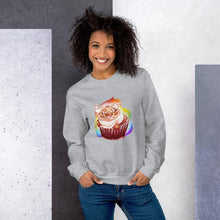 Load image into Gallery viewer, A woman wears a unisex sweatshirt in the colour sport grey, printed with an illustration of a cat painted as a red velvet cupcake with rainbow sprinkles.
