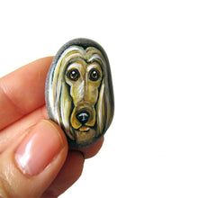 Load image into Gallery viewer, a small beach stone, hand painted with a portrait of an Afghan Hound dog, available as a keepsake stone or necklace. 
