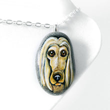 Load image into Gallery viewer, a small beach stone, hand painted with a portrait of an Afghan Hound dog, available as a keepsake stone or necklace. 
