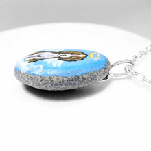 Load image into Gallery viewer, a small beach stone hand painted with a brown and white Springer spaniel dog as an angel sitting on clouds. available as a keepsake or pendant necklace
