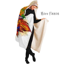 Load image into Gallery viewer, a man is wearing the Autumn Fairy Cats Hooded Blanket with microfleece lining, featuring art of a white/orange  cat, and black/blue cat, each with leaf wings
