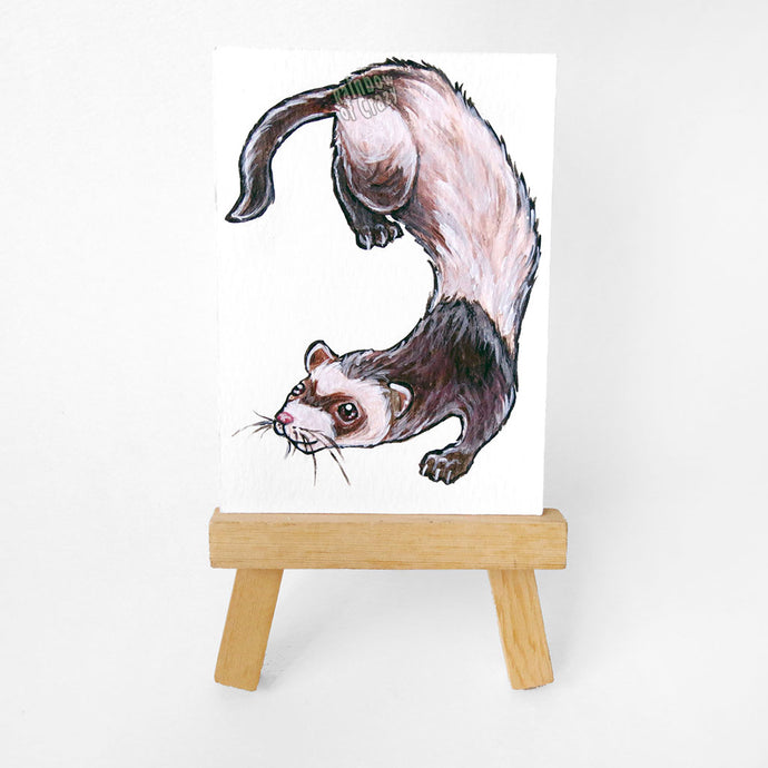 An original ACEO painted with a portrait of a ferret. Displayed on a mini wooden easel