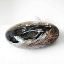 Load image into Gallery viewer, a small beach stone, hand painted with a portrait of a smiling ferret with its tongue out
