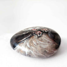 Load image into Gallery viewer, a small beach stone, hand painted with a portrait of a smiling ferret with its tongue out
