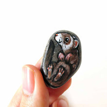 Load image into Gallery viewer, a small beach stone, hand painted with a portrait of a smiling ferret, available as a keepsake rock art, or pendant necklace
