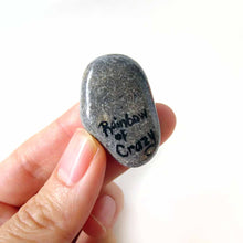 Load image into Gallery viewer, a small beach stone, hand painted with a portrait of a smiling ferret, available as a keepsake rock art, or pendant necklace, back signed with, Rainbow of Crazy
