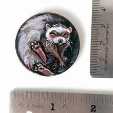 Load image into Gallery viewer, a ferret sleeping, hand painted on a circle wood disc, available as a keepsake or pendant necklace
