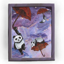 Load image into Gallery viewer, art print featuring three giant panda bears flying through a purple sky, each holding on to a red umbrella
