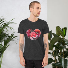 Load image into Gallery viewer, A man is wearing the Fox Love Premium Unisex T-shirt in the colour dark heather grey, which includes a graphic of a red fox sleeping in the shape of a heart.
