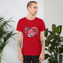 Load image into Gallery viewer, A man is wearing the Fox Love Premium Unisex T-shirt in the colour red, which includes a print of a red fox sleeping in the shape of a heart.
