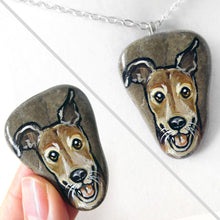 Load image into Gallery viewer, a beach rock painted with art of a close-up of a brown greyhound smiling, available as a stone or necklace
