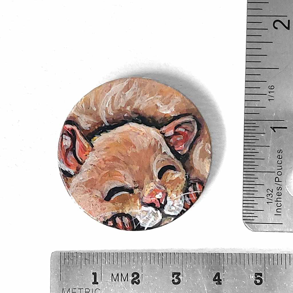a smooth wood circle, hand painted with a sleeping hamster. available as a keepsake or pendant necklace