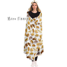 Load image into Gallery viewer, a woman wearing the Happy Cookies Hooded Blanket, featuring 10 illustrated smiling cookies patterned all over, lined with micro fleece
