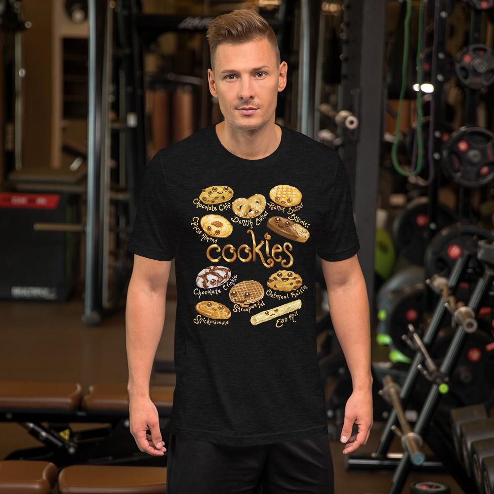 A man wearing the Happy Cookies Premium Unisex T-Shirt in the colour black heather, featuring artwork of ten different types of cookies with smiling faces