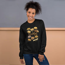 Load image into Gallery viewer, A woman is wearing the Happy Cookies Unisex Sweatshirt in the colour black, which features a graphic of 10 different types of cookies with smiley faces
