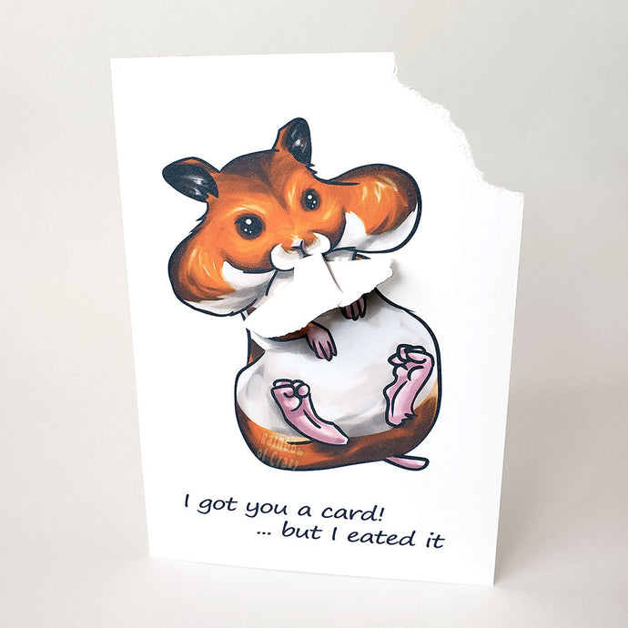 A greeting card featuring art of a Syrian hamster with big, full cheeks, with the text, 