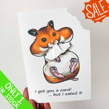 Load image into Gallery viewer, A greeting card featuring art of a Syrian hamster with big, full cheeks, with the text, &quot;I got you a card! ... but I eated it&quot;. The top right corner of the card is ripped off and is attached to the hamster&#39;s mouth.
