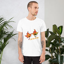 Load image into Gallery viewer, A man wearing the I Believe in You Leaf Premium Unisex T-Shirt in the colour white, which includes a graphic of two maple leaves and the words, &quot;I be-leaf in you&quot;
