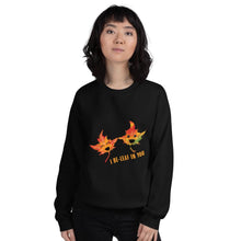 Load image into Gallery viewer, A woman is wearing a unisex sweatshirt in the colour black, featuring art of two smiling maple leaves with the words, &quot;I Be-Leaf In You&quot;
