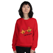 Load image into Gallery viewer, A woman is wearing a unisex sweatshirt in the colour red, featuring a graphic of two smiling maple leaves with the words, &quot;I Be-Leaf In You&quot;
