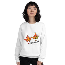 Load image into Gallery viewer, A woman is wearing a unisex sweatshirt in the colour white, featuring an image of two smiling maple leaves with the words, &quot;I Be-Leaf In You&quot;
