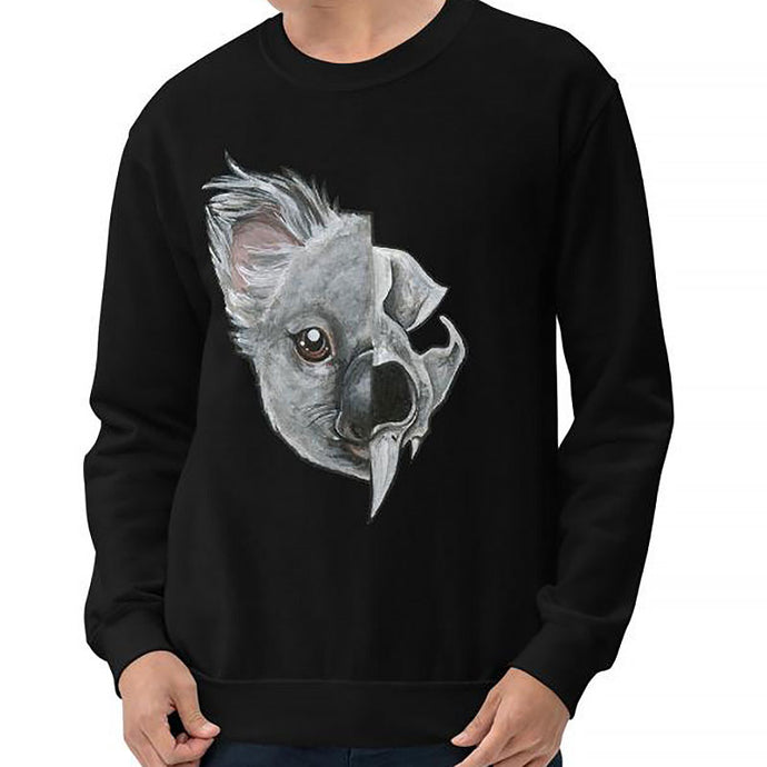 A man is wearing a unisex sweatshirt in the colour black, printed with an illustration split into two: the left side features the face of a koala bear, and the right side features an evil looking koala skull.