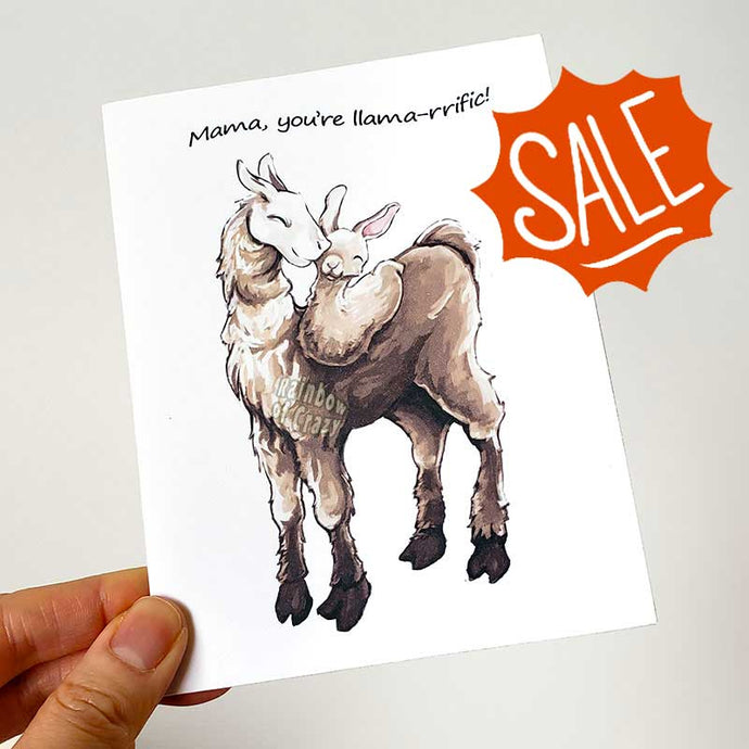 A greeting card with an illustration of a white and brown llama, with a baby llama curled up on its back. The card reads, 