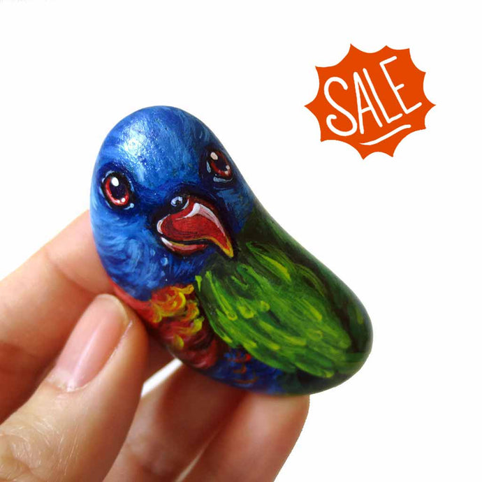 small rock art, hand painted with a rainbow lorikeet bird with red eyes