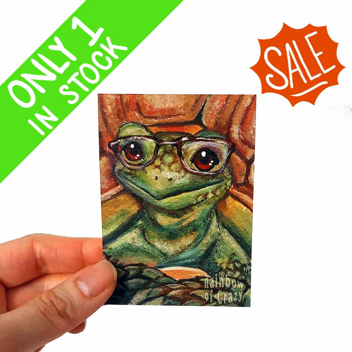 an aceo art print featuring a portrait of a tortoise, wearing dark brown eyeglasses