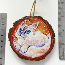 Load image into Gallery viewer, A wooden ornament with a painting of a white Ragamuffin cat with blue eyes, next to two rulers to show its size: 2 15/16 x 3 1/8 inches or 7.5 x 8 cm
