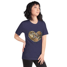 Load image into Gallery viewer, A woman wearing the Otters Love Premium Unisex T-Shirt in the colour heather midnight navy blue, which includes an illustration of two otters forming the shape of a heart.
