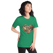 Load image into Gallery viewer, A woman wearing the Otters Love Premium Unisex T-Shirt in the colour kelly green which includes a graphic of two otters forming the shape of a heart.
