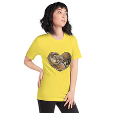 Load image into Gallery viewer, A woman wearing the Otters Love Premium Unisex T-Shirt in the colour yellow, which includes art of two otters forming the shape of a heart.
