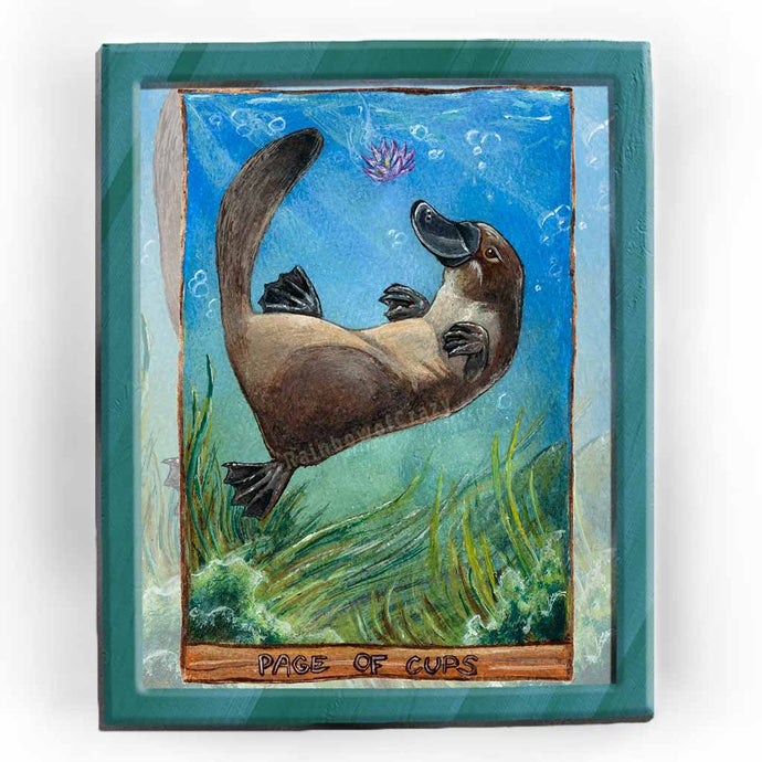  an art print of the page of cups tarot card, from the animism tarot deck: a platypus swims in the ocean, playing with a purple lotus flower, with seaweed swaying below