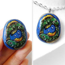 Load image into Gallery viewer, small rock art featuring a painting of two green fish, swimming in the shape of a circle, representing the sign of pisces, available as a keepsake or necklace
