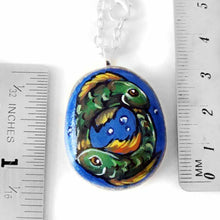 Load image into Gallery viewer, necklace featuring a painting of two green fish, swimming in the shape of a circle, representing the sign of pisces
