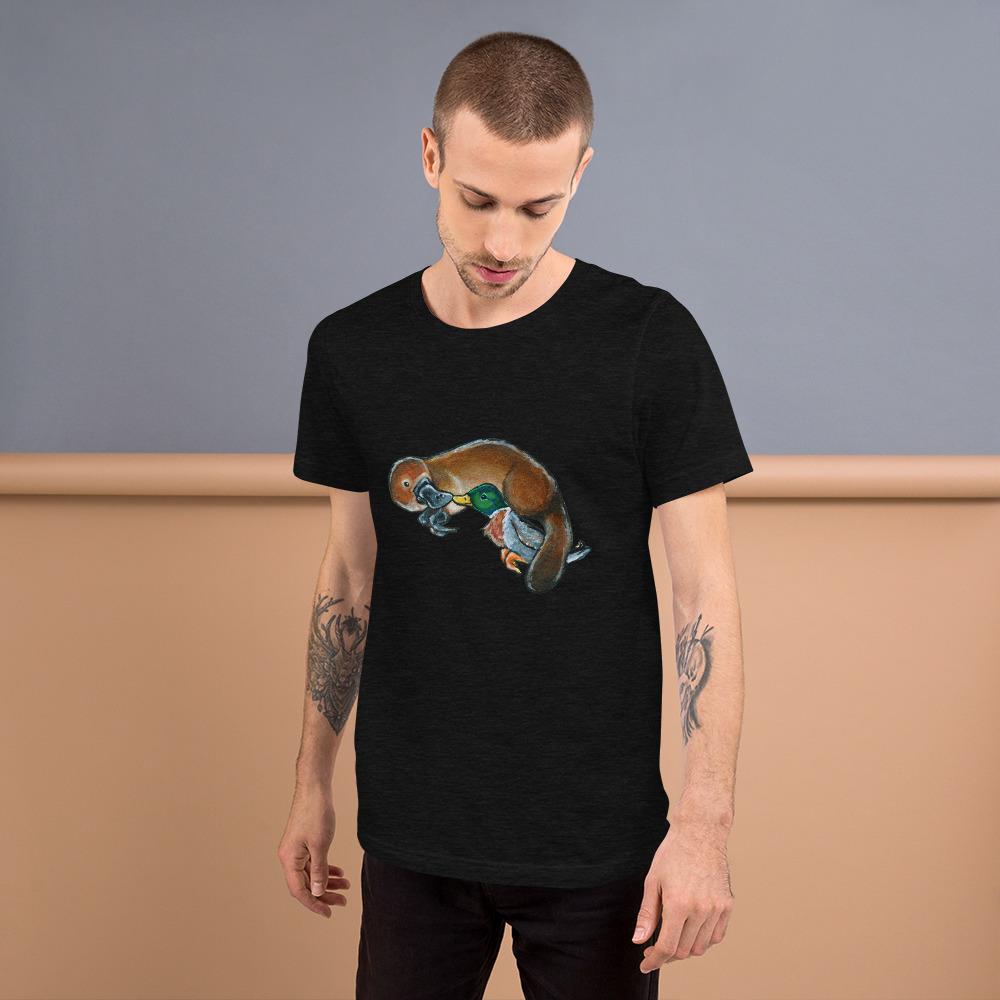 A man is wearing the Platypus Duck Premium T-Shirt in the colour black heather, which includes a print of platypus kissing a mallard duck