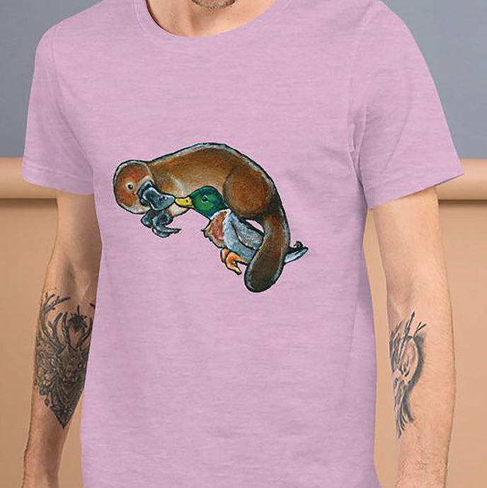 A man is wearing the Platypus Duck Premium T-Shirt in the colour heather prism lilac, which is printed with art of platypus kissing a mallard duck