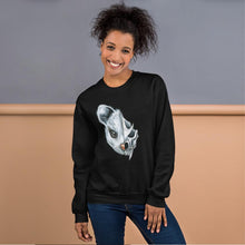 Load image into Gallery viewer, A woman wears a unisex sweatshirt in the colour black, printed with artwork of a split image: the left side features a possum&#39;s face, and the right side features an evil looking possum skull.

